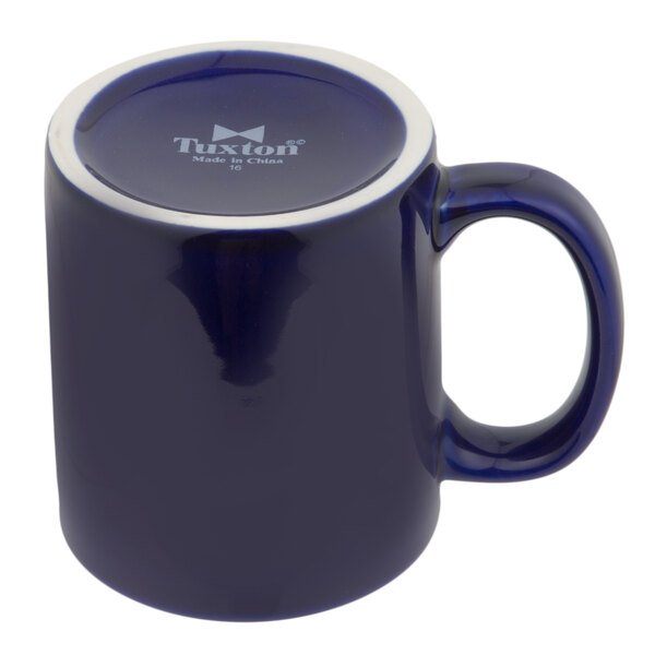 A blue mug with a white rim and handle.