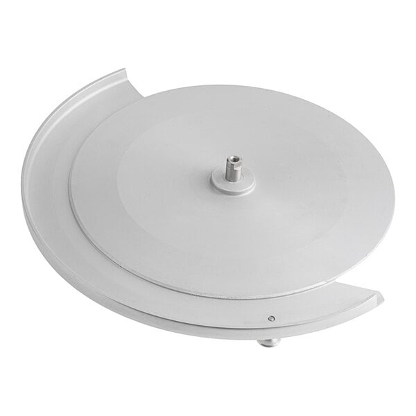 A round metallic disc with a central mounting post and a partial outer rim, likely a component cover or guard.