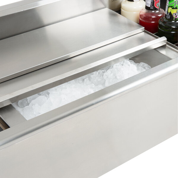 A stainless steel Eagle Group underbar ice chest filled with ice, drinks, and bottles.