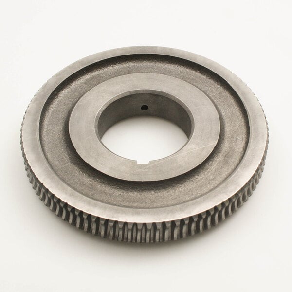 A circular metal Groen gear with a hole in it.