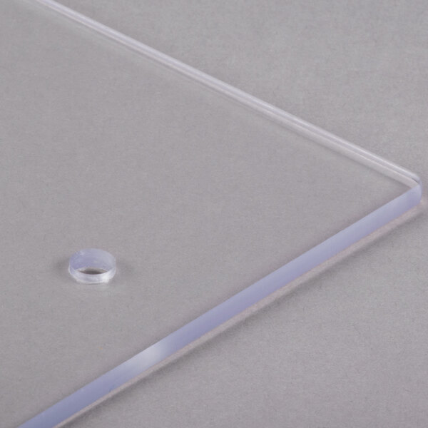 A clear plastic panel with a hole in it.