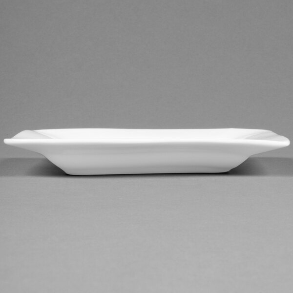 A CAC Miami bone white square porcelain plate with a black stripe on the edge.