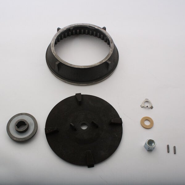 A black and silver circular metal clutch kit with a bearing and nut.