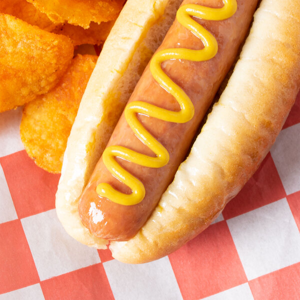 A hot dog with Admiration yellow mustard on top of a bun.