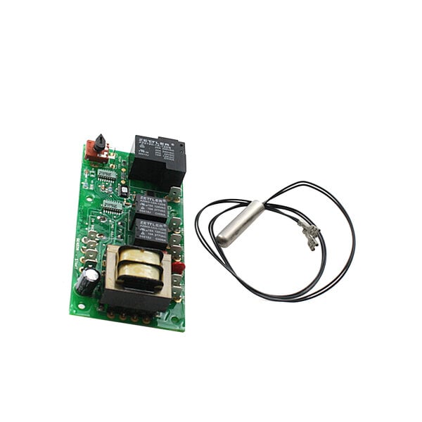 A Wells electronic timer kit with a green circuit board and wires.