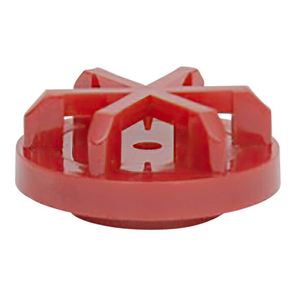 A close-up of a red plastic star-shaped Wilbur Curtis spray head.