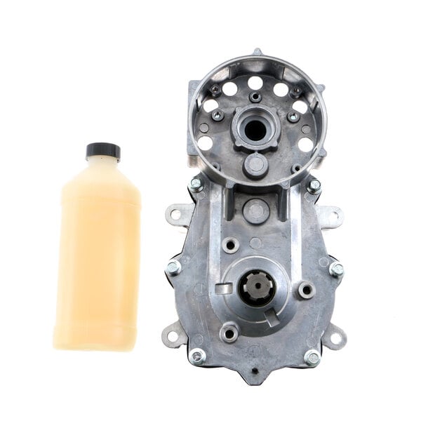 A Scotsman gearbox assembly with metal gears and a bottle of oil.