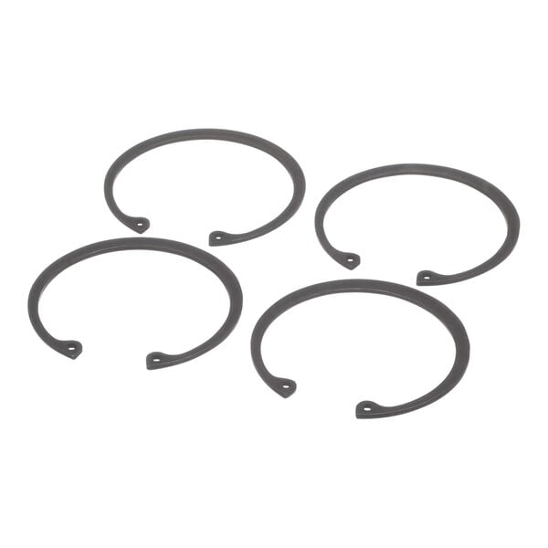 A group of four black circular rubber rings.