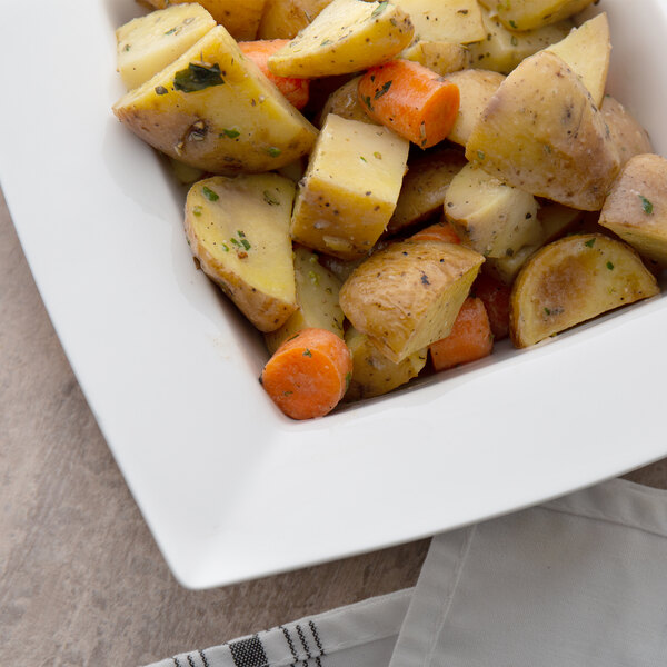 A 10 Strawberry Street Whittier white square porcelain bowl filled with cubed yellow and white food.