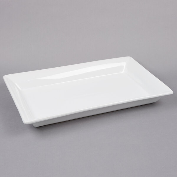 A white rectangular American Metalcraft stoneware platter on a gray surface.