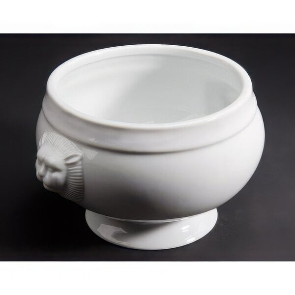 A CAC bright white porcelain bowl with a lion head on it.