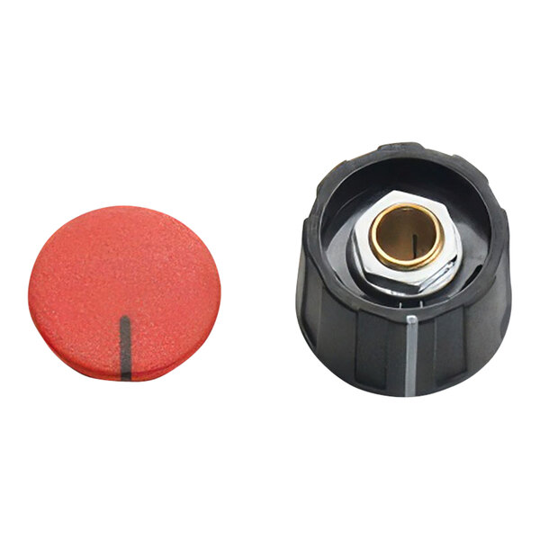 A red and black plastic cap with a red knob over a black and gold nut.