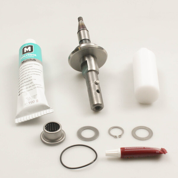 A Robot Coupe 29693 shaft assembly with a circular metal part and a tube of glue.