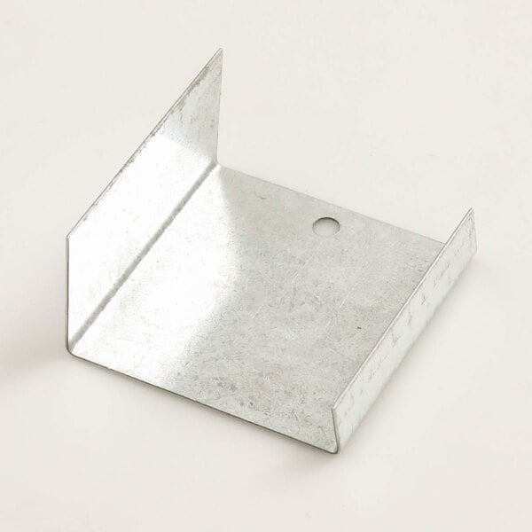 A metal bracket with a hole in it used to cover a drop-in food warmer drain.