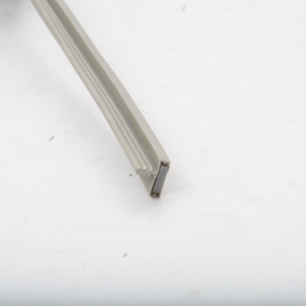 A close-up of a plastic strip with a small hole in it.