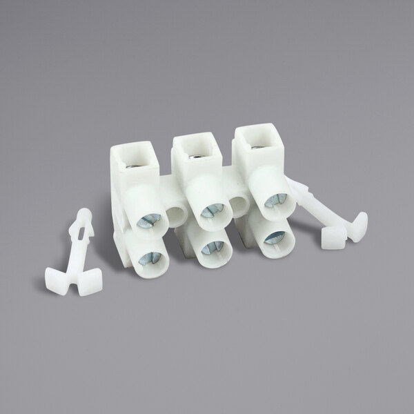 A white plastic Hatco terminal block with three plugs.