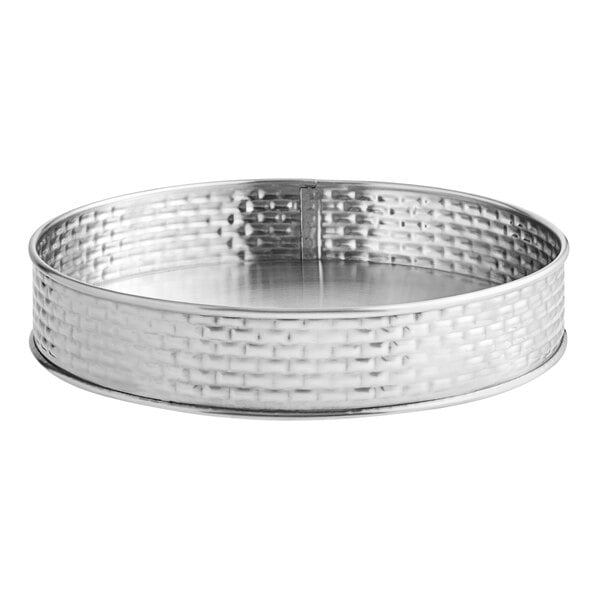A silver round metal platter with a patterned design.