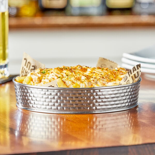 A Tablecraft stainless steel platter with food on it.