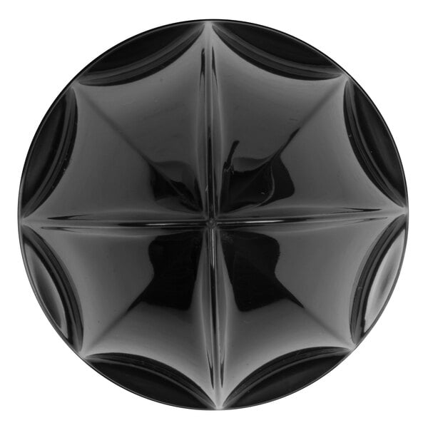 A black circular object with a star pattern.