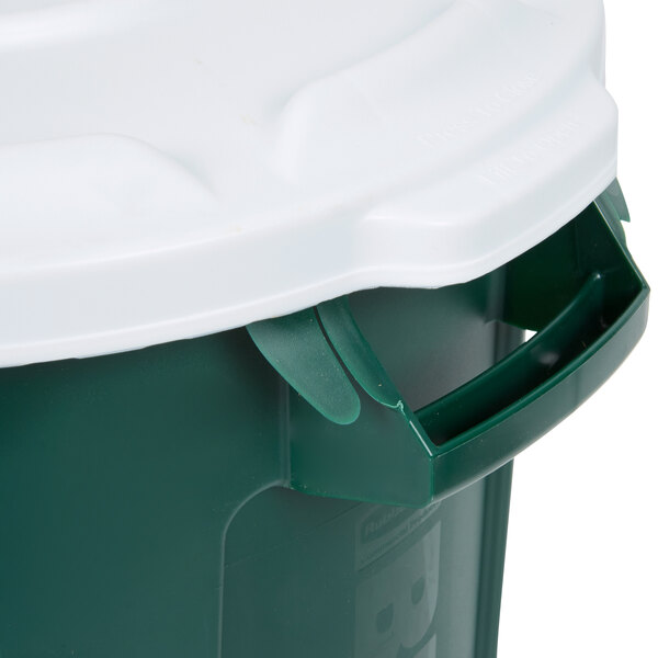 A green Rubbermaid commercial trash can with a white lid.
