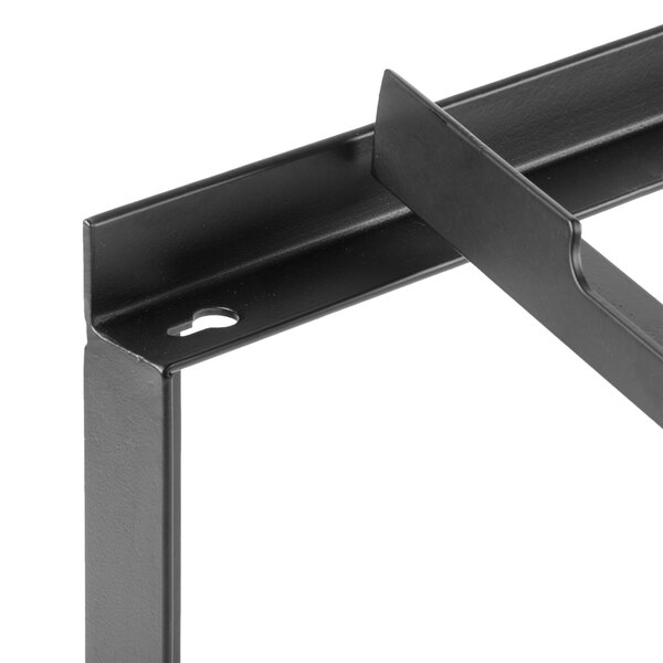 A black metal display riser with two holes in the middle.