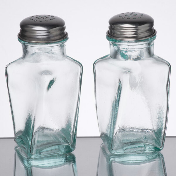 Two Tablecraft green tint glass salt and pepper shakers with silver lids.