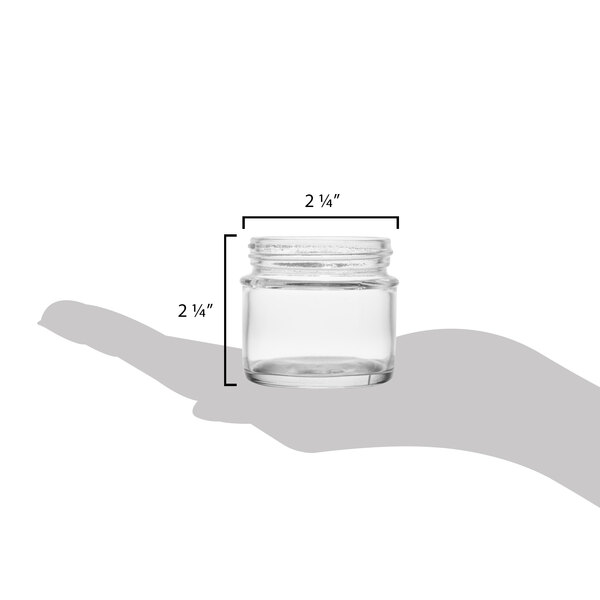 A hand holding a Tablecraft glass tasting jar with a lid.