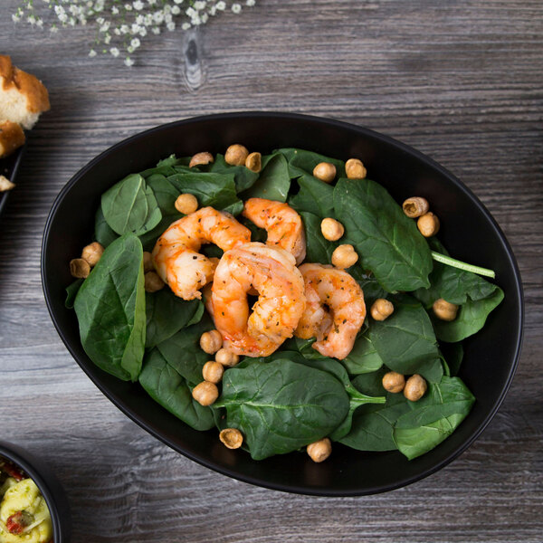 A Libbey Driftstone Onyx porcelain bowl filled with spinach and shrimp.