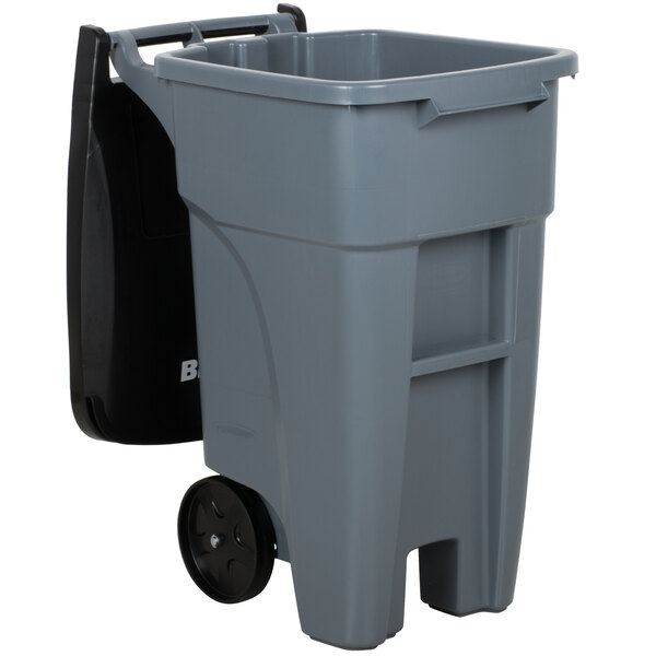 A Rubbermaid grey rectangular trash can with black wheels and a black lid.