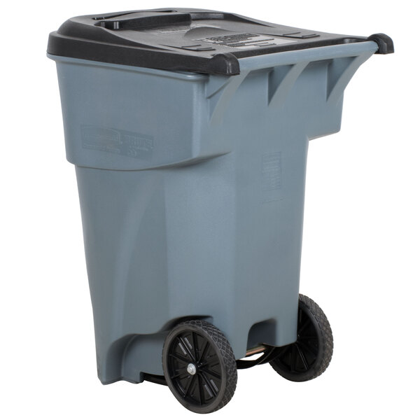 A gray Rubbermaid industrial trash can with black wheels.
