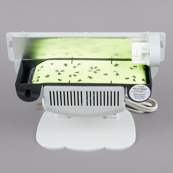 A white Paraclipse Fruit Fly Patrol machine with a green light.