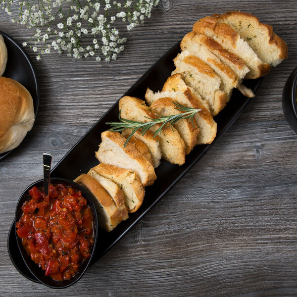 A Libbey Driftstone Onyx Satin Matte porcelain bowl filled with bread on a table.