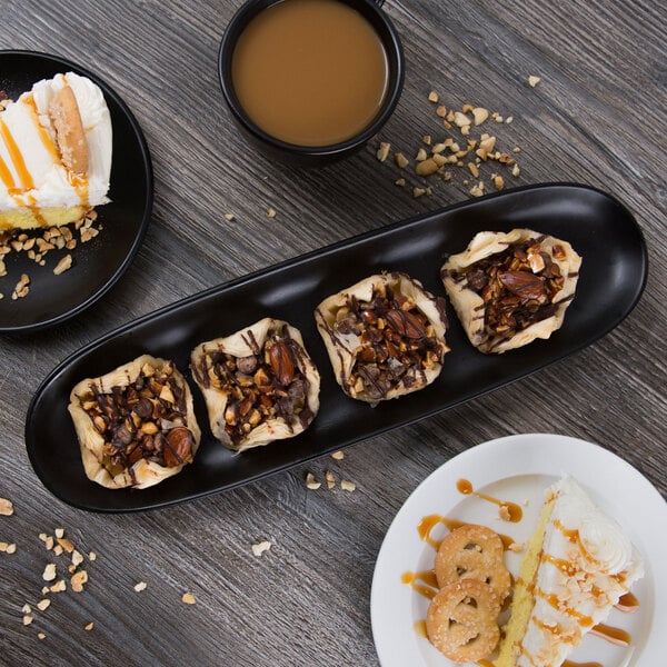 A Libbey Driftstone porcelain tray with a plate of desserts and coffee on a table.