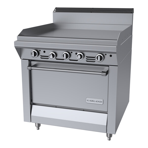 A commercial stainless steel griddle with manual controls and an integrated oven.