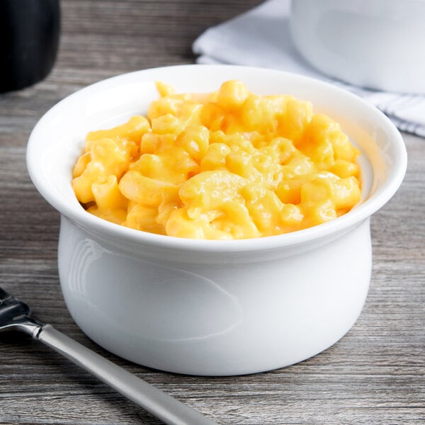 A white Libbey porcelain casserole dish filled with macaroni and cheese on a table.