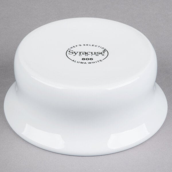 A Libbey white porcelain pot pie dish with black text on the side.