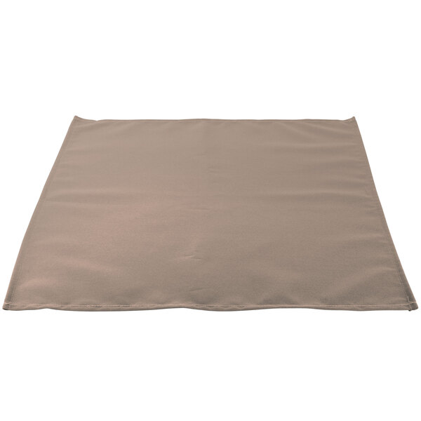 A close-up of a beige Intedge cloth napkin.