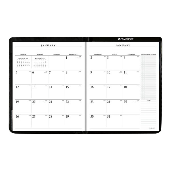 A black At-A-Glance monthly calendar page in a notebook.