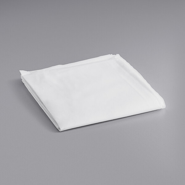 A folded white Hoffmaster Linen-Like table cover.