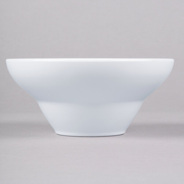 A close-up of an Elite Global Solutions white melamine bowl.