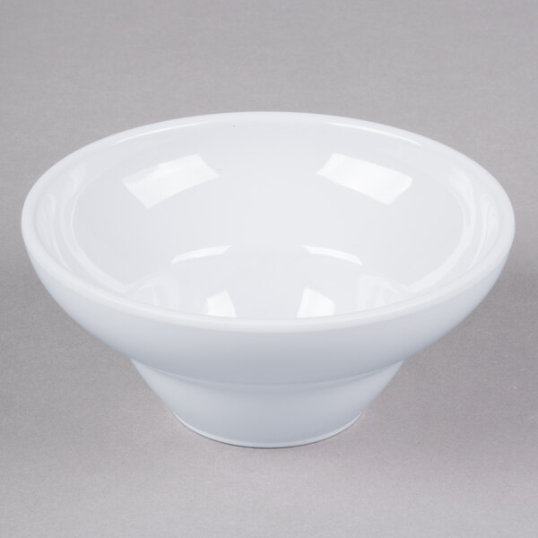 A white Elite Global Solutions melamine bowl with a small rim on a gray surface.