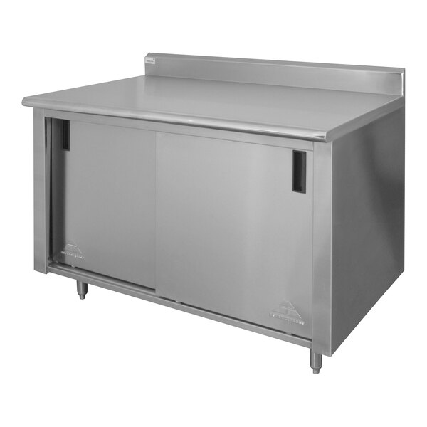 A stainless steel Advance Tabco work table with cabinet base.