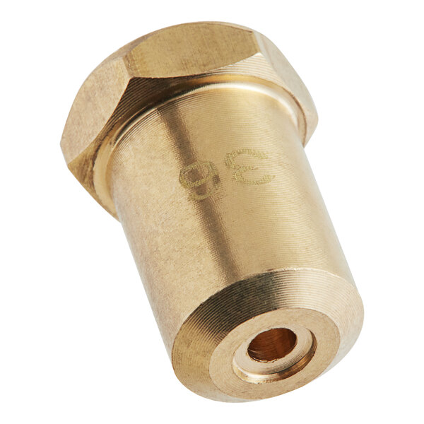 A brass Cooking Performance Group #36 burner orifice with a hole in the middle and a gold nut.