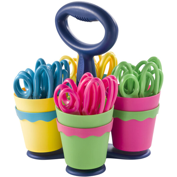A Westcott caddy filled with green and pink handled kids scissors.