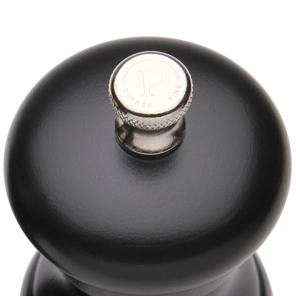 A Chef Specialties black pepper mill with a silver top.