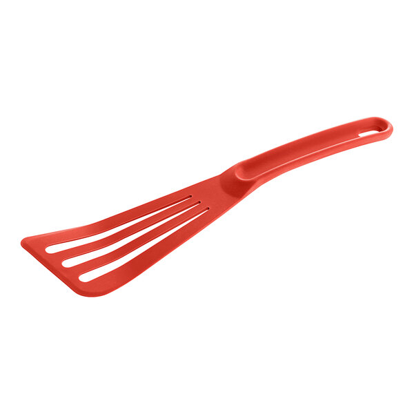 A red plastic slotted turner with a handle.