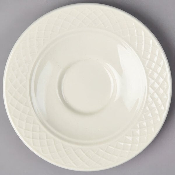 A white Homer Laughlin china saucer with a circular pattern on the edge.