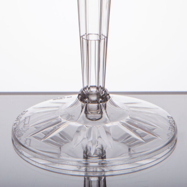 A clear plastic champagne flute with a clear stem and base.