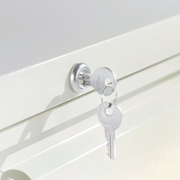 The key in the lock of a light gray Alera metal lateral file cabinet drawer.