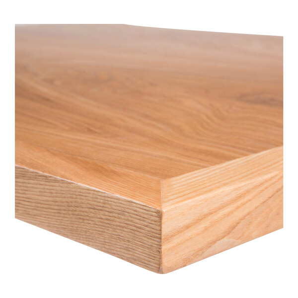 A close up of a BFM Seating natural ash veneer table top.